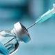 Peptide vial with syringe preparing to perform research
